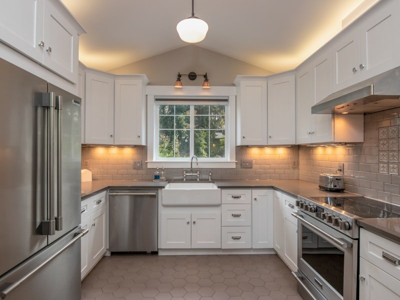 Classic Winnipeg kitchen renovation with farmhouse sink, schoolhouse pendant, and white shaker cabinetry