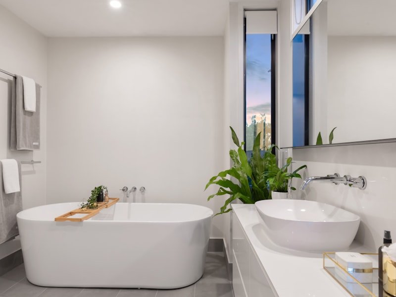 Accessible spa bathroom with freestanding tub, vessel sink, and clear walk-through layout